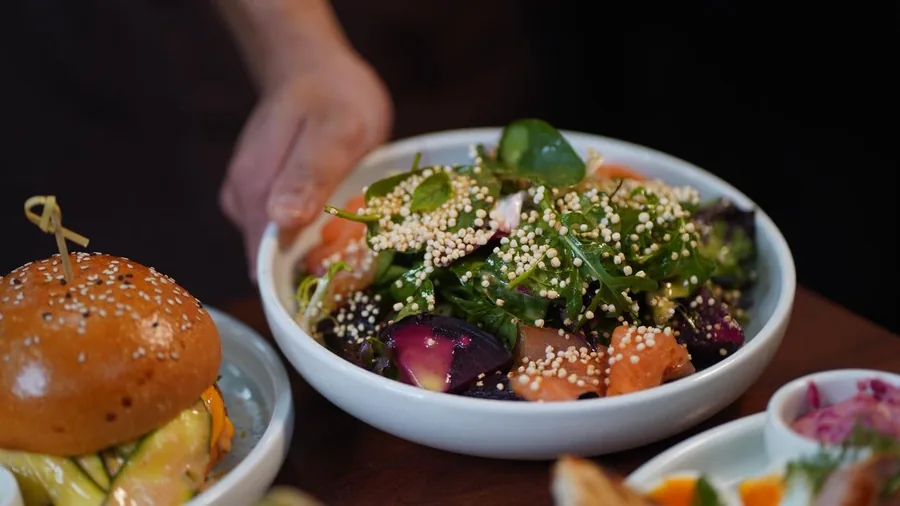 Burger with a fresh garden salad bowl at Cafe Cosy Moss Vale